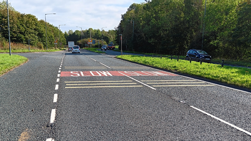 Yellow road markings on approach to roundabout